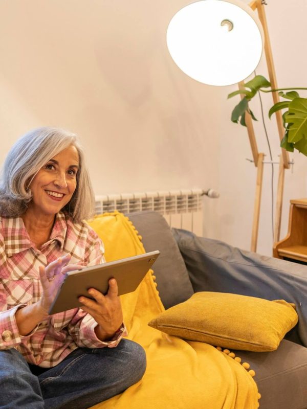 gray-haired-mature-woman-smart-home-home-control-on-tablet-use-smart-home-app.jpg