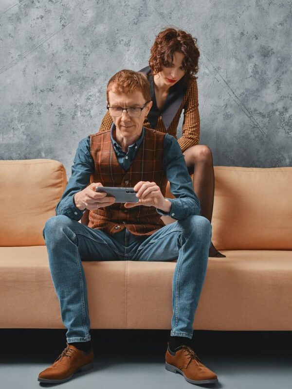 middle-aged-man-adjusts-control-of-smart-home-on-smartphone-e1745464345798.jpg